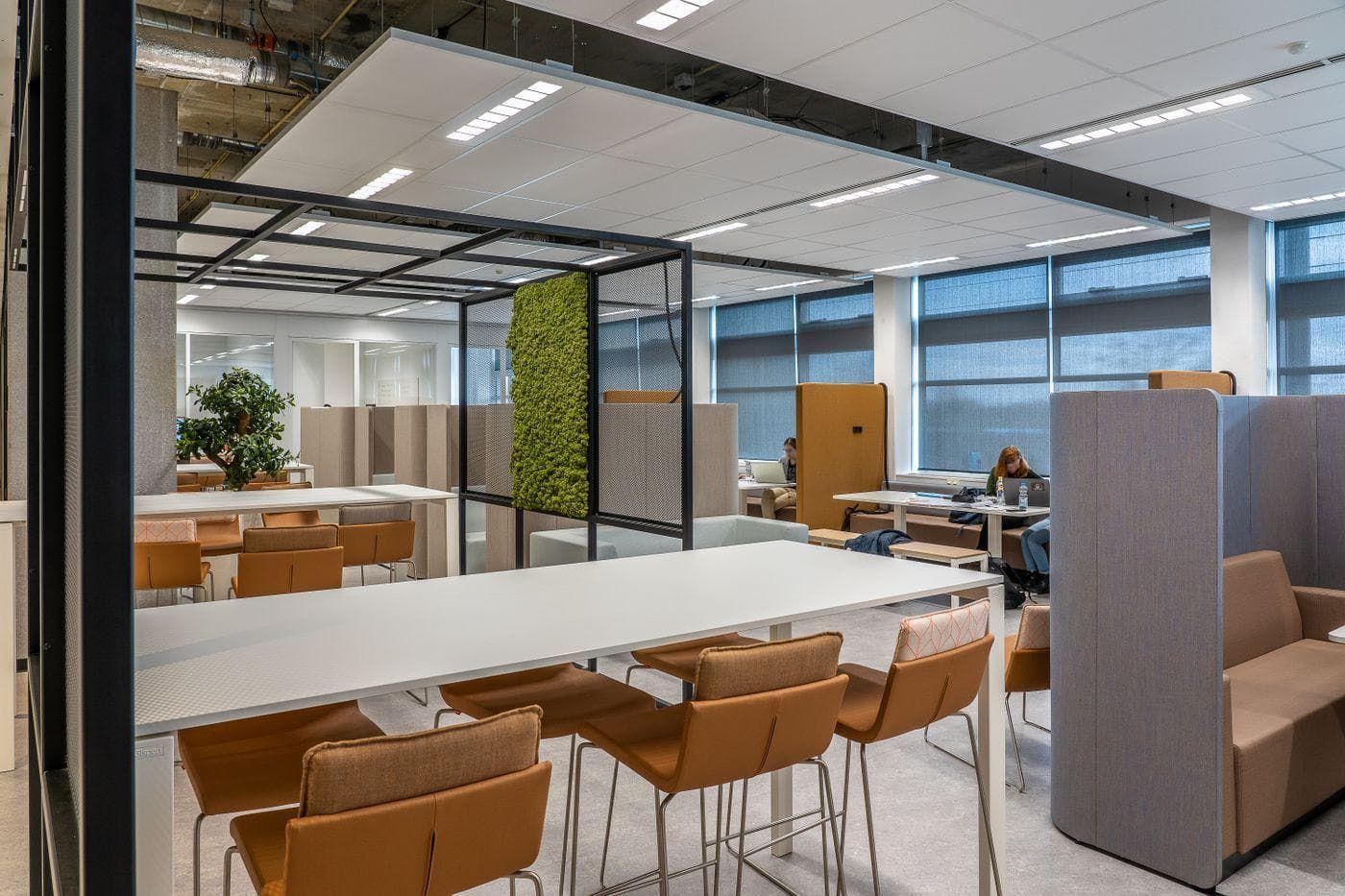 An open-plan office with clean tables, chairs and floors ready for the working day